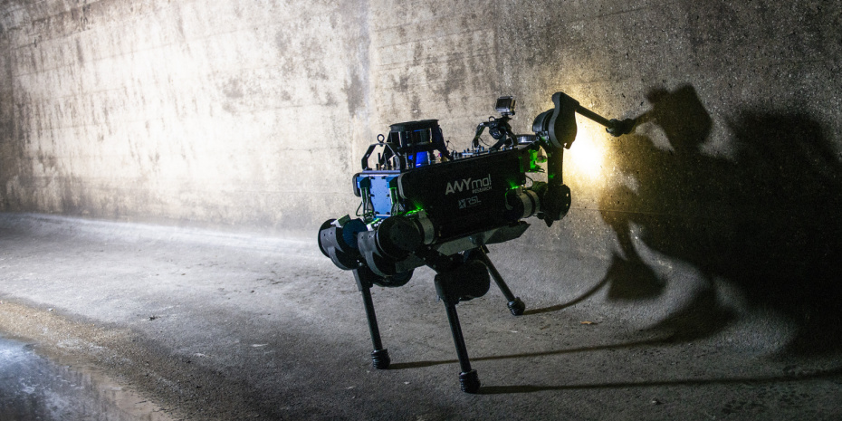 Quadruped robot using force-torque sensors to interact with a wall and simulate a sense of touch.